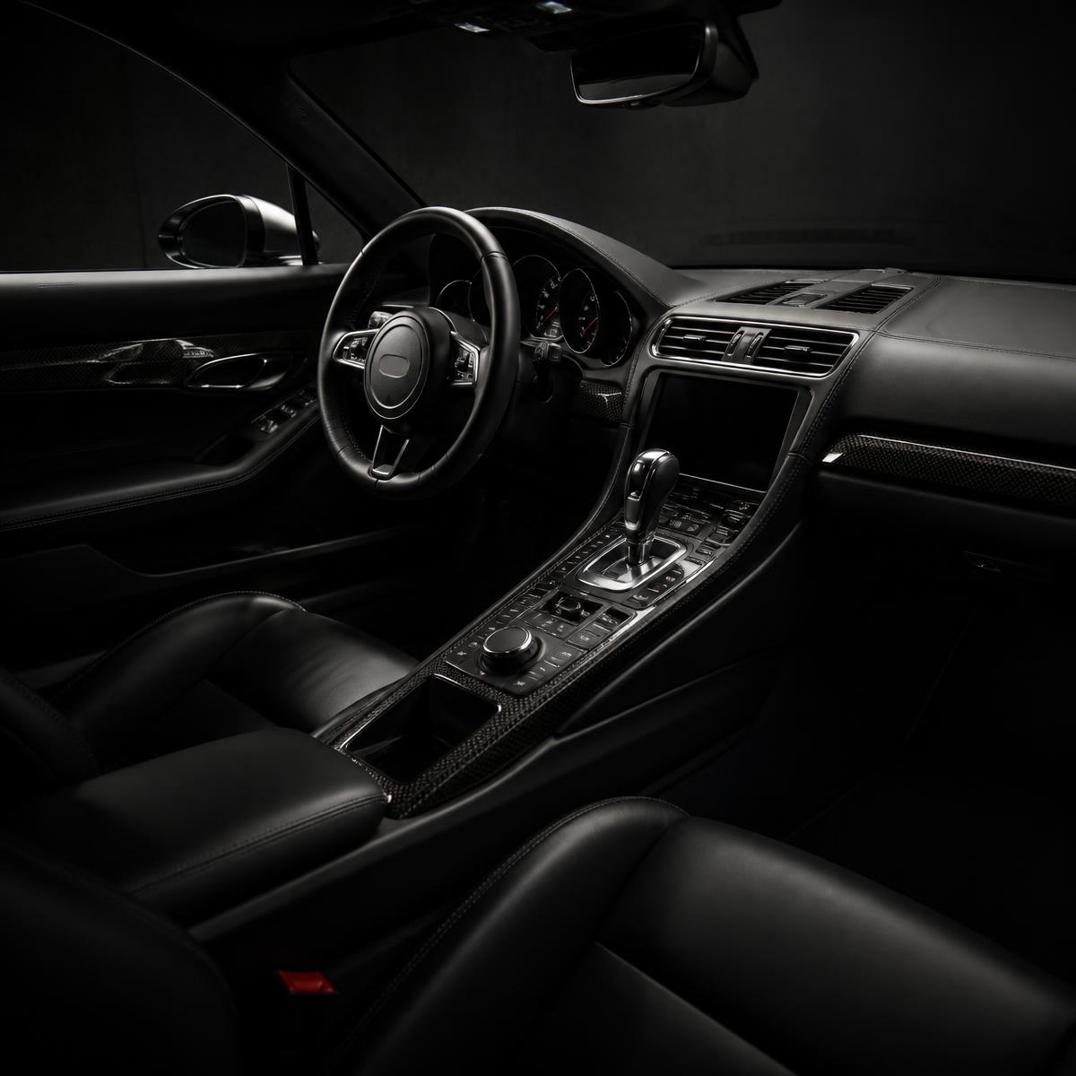 Freshly detailed black leather and carbon fibre car interior